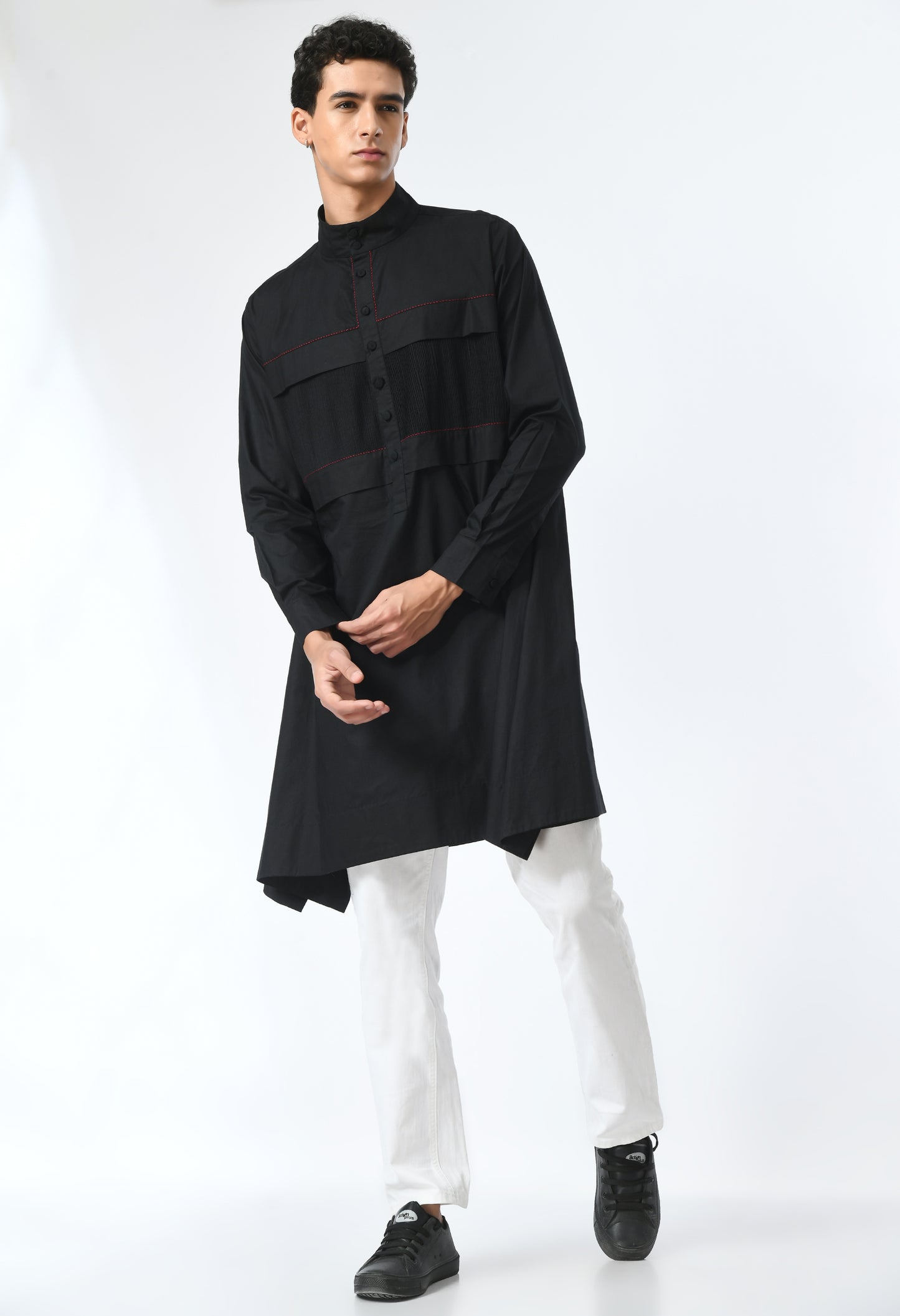 Long unisex black shirt, with a round closed Chinese collar.