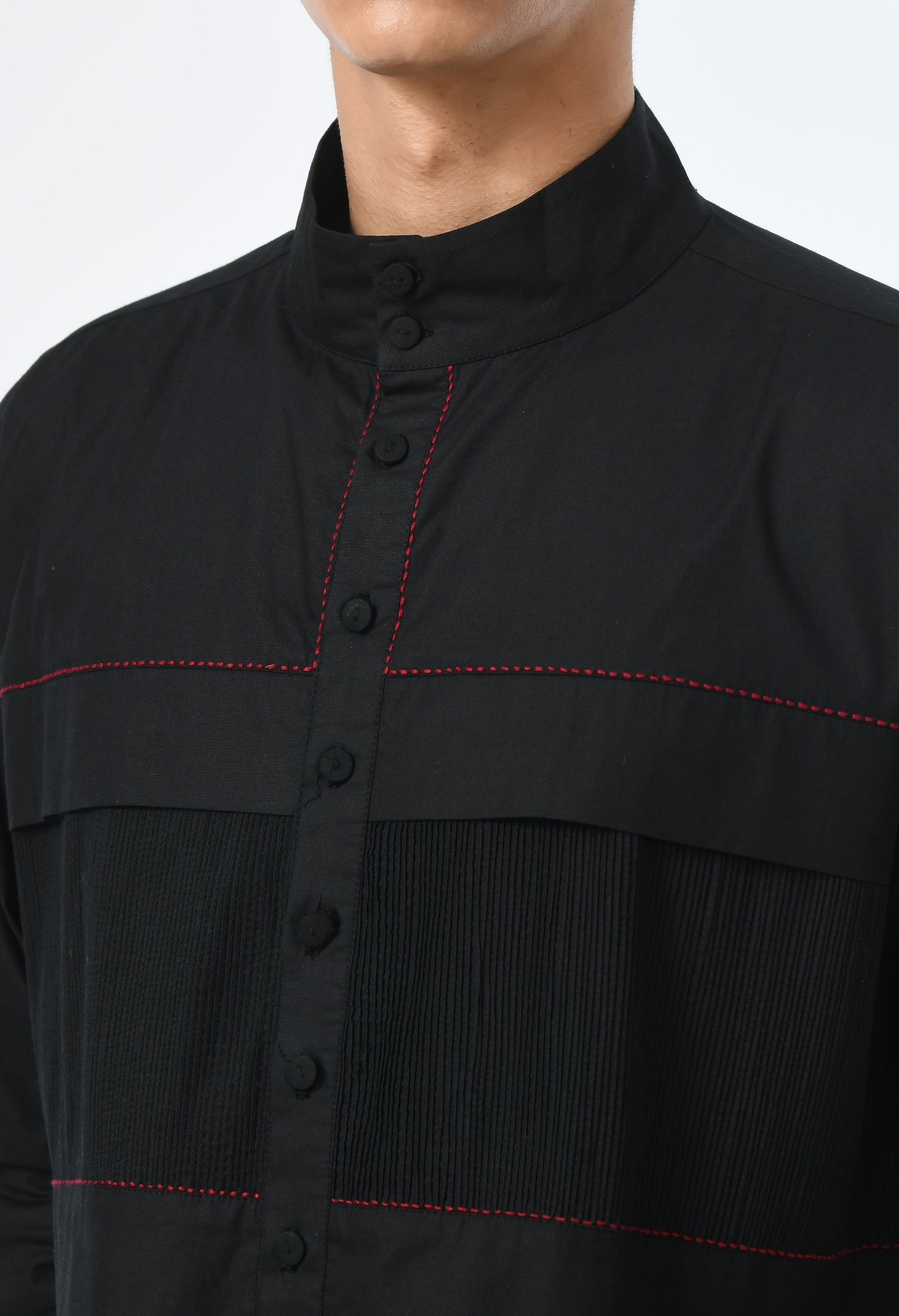 Long unisex black shirt, with a round closed Chinese collar.