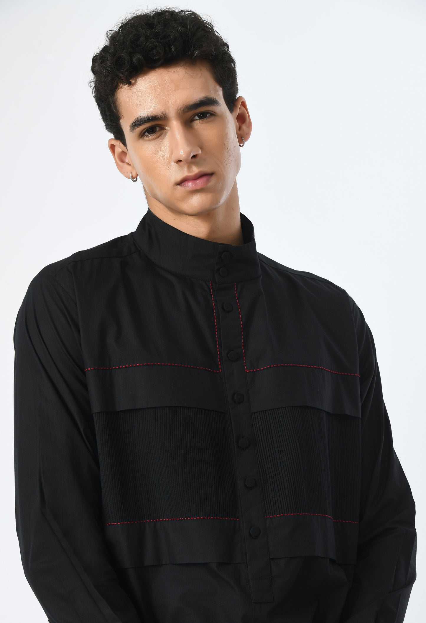 Long unisex black shirt, with a round closed Chinese collar.