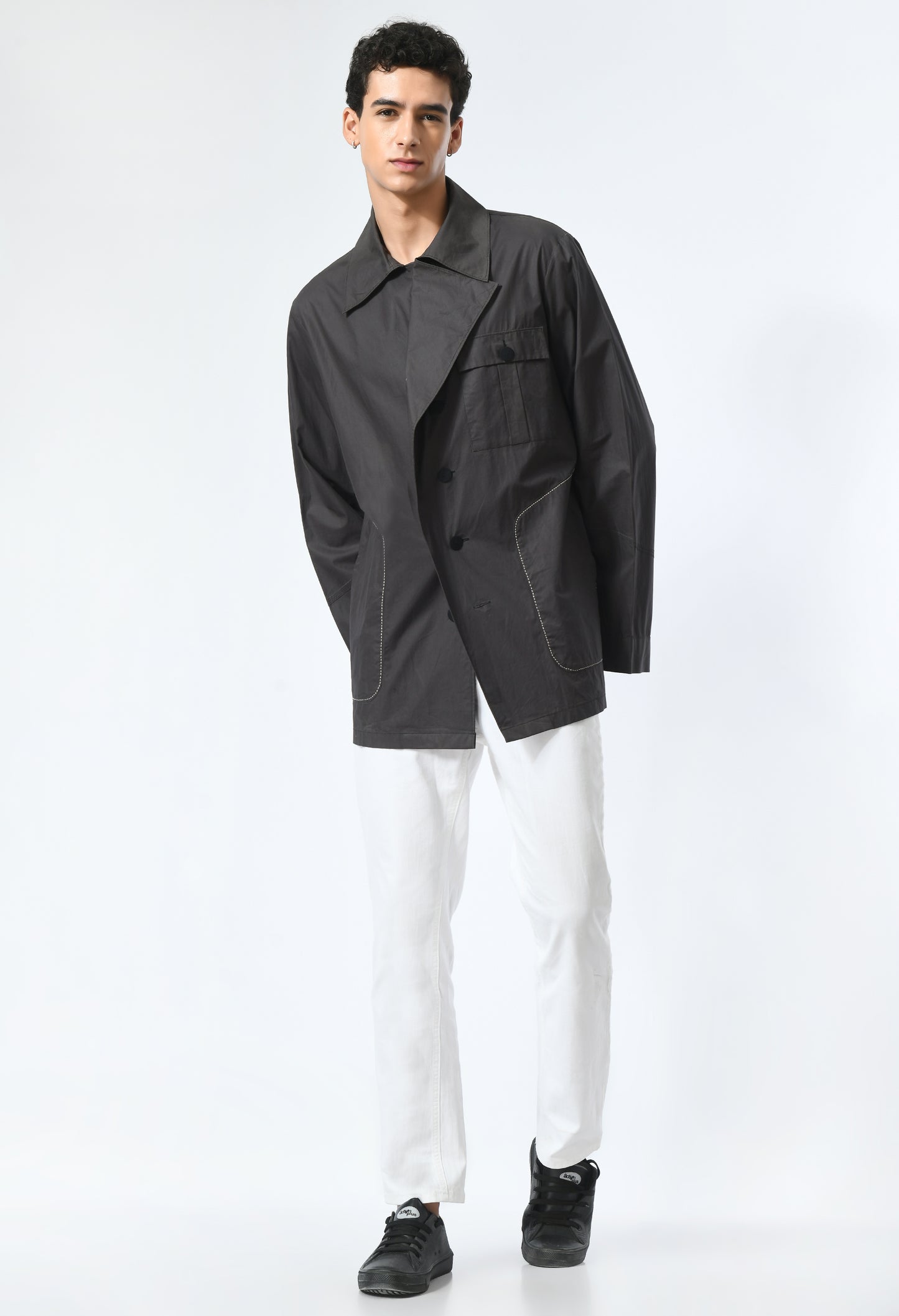 Black jacket featuring flap on front.