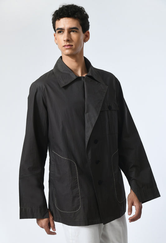 Black jacket featuring flap on front.