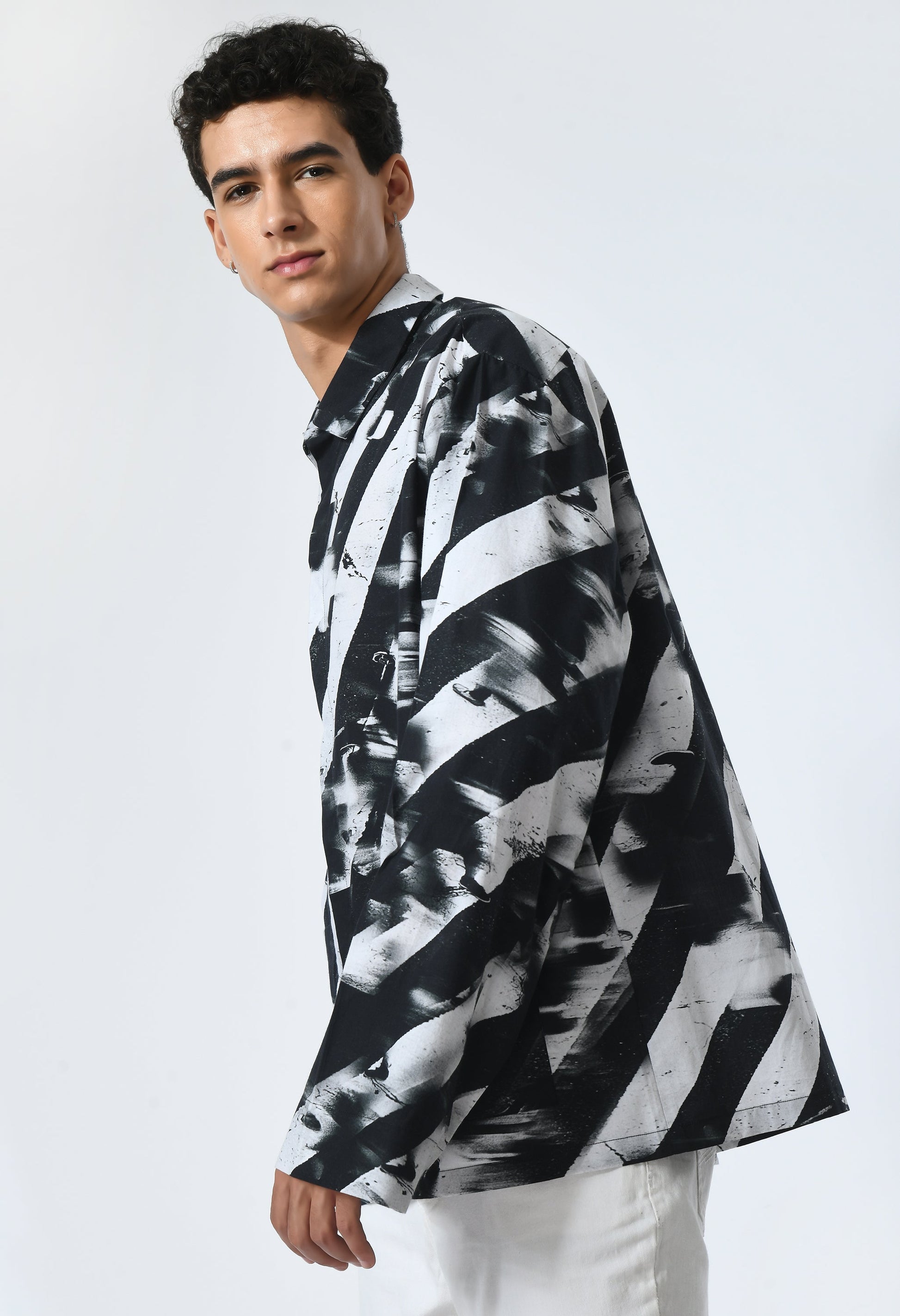 Man wearing BINARY STRIPES SHIRT in soft cotton, featuring a black and white print inspired by Bombay to Tokyo journey.