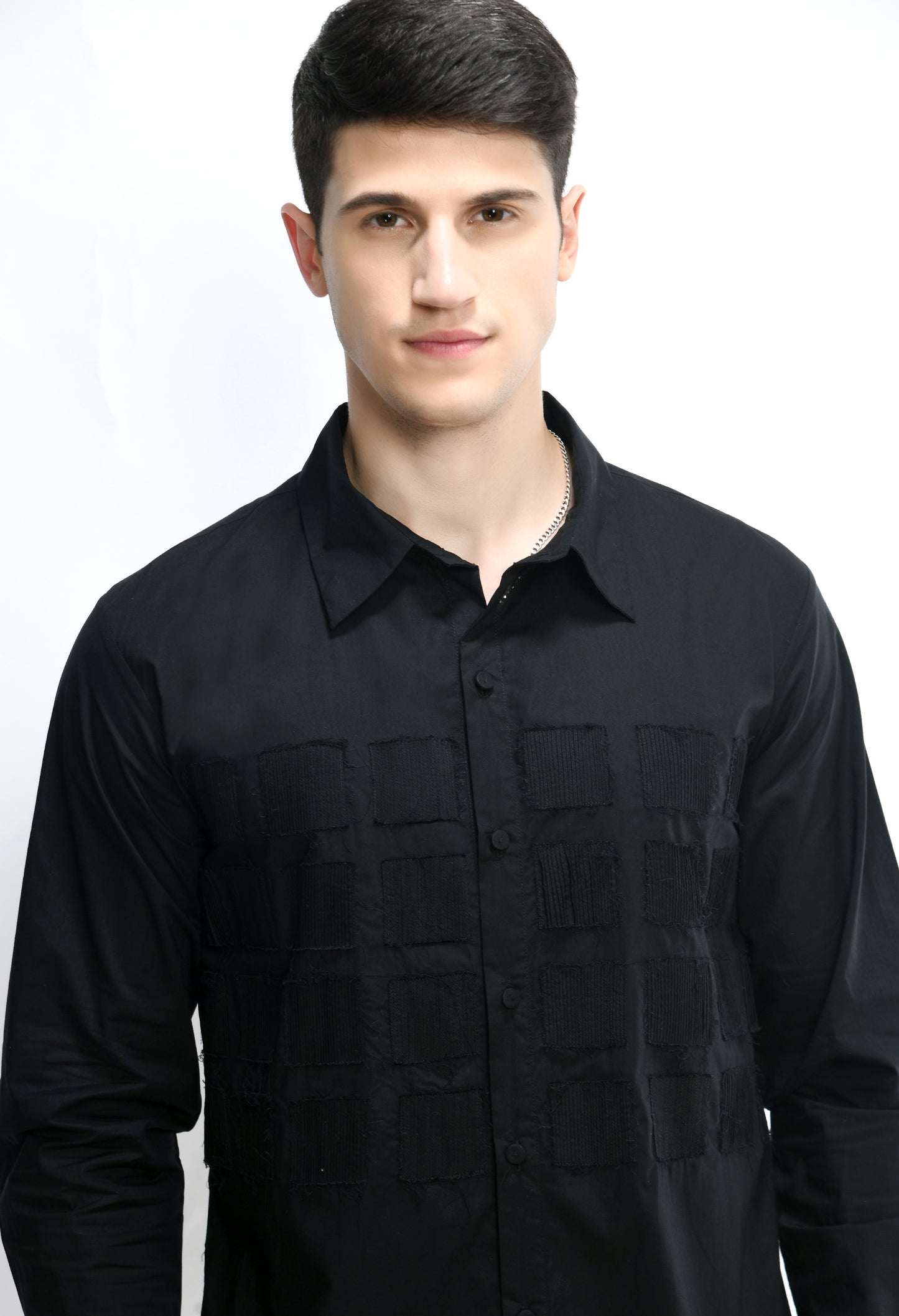 A black cotton shirt showcasing tone on tone pintuck work in form of small square cut design.