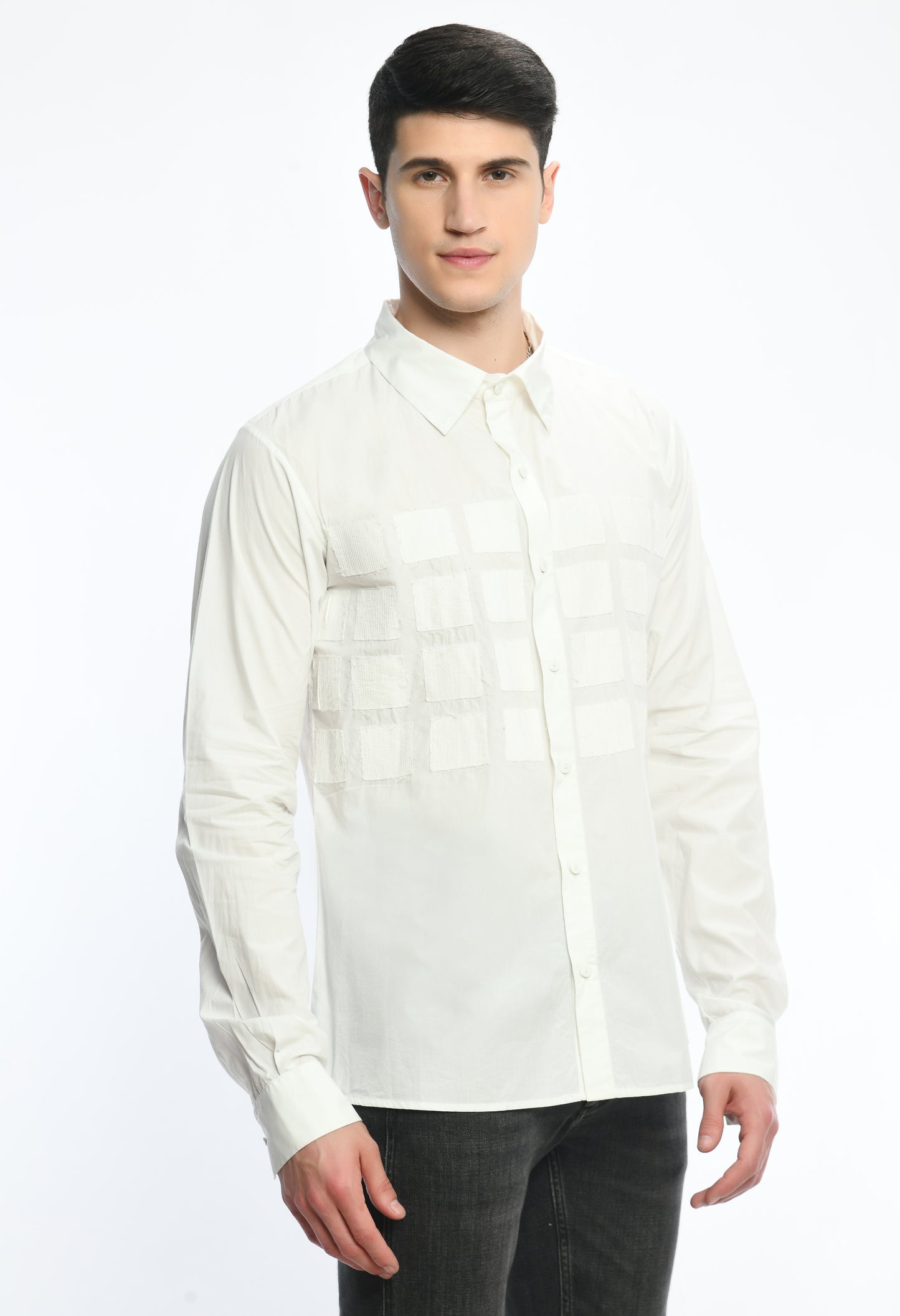 A White cotton shirt showcasing tone on tone appliqué work in form of small square cut design.