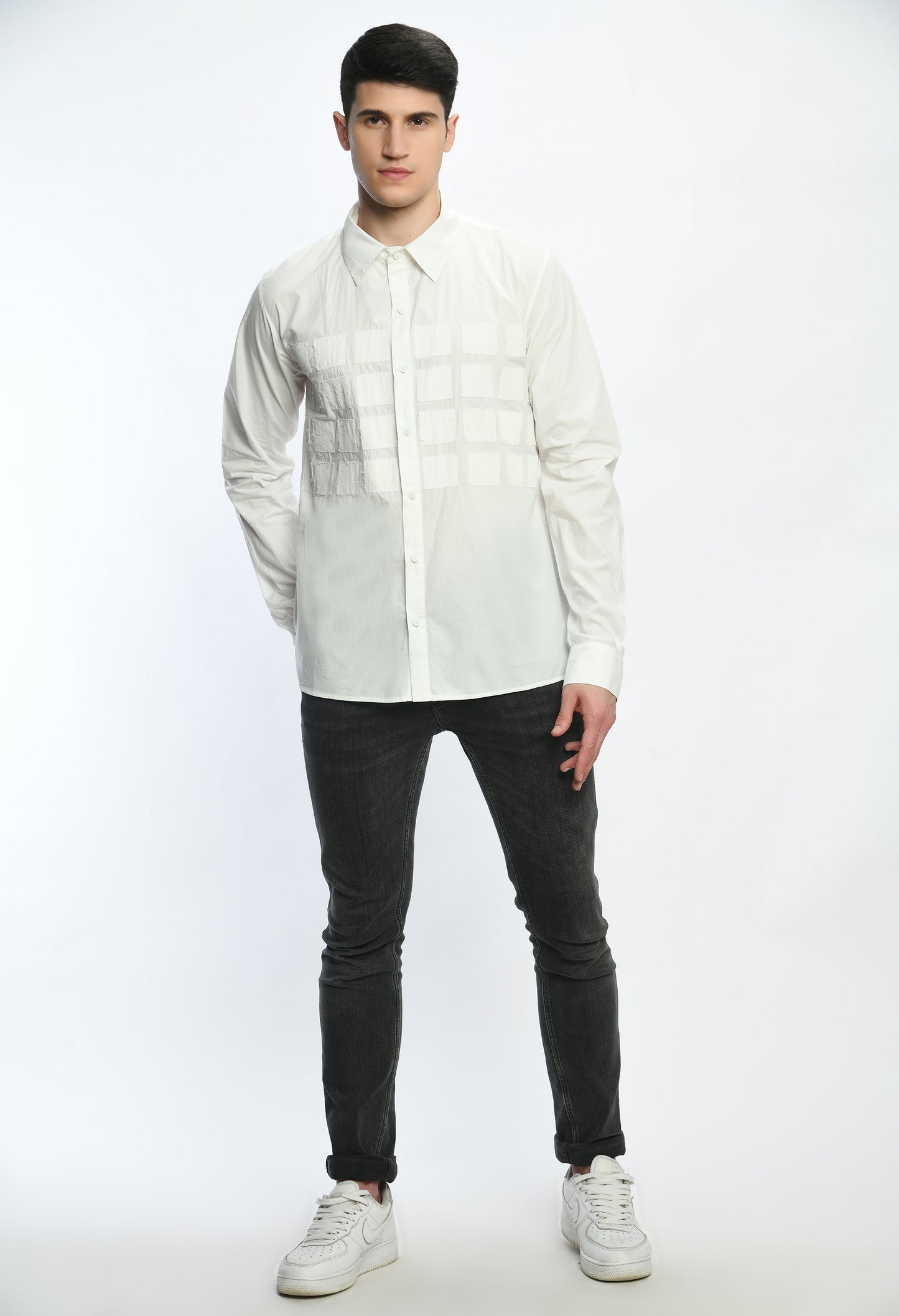 A White cotton shirt showcasing tone on tone appliqué work in form of small square cut design.