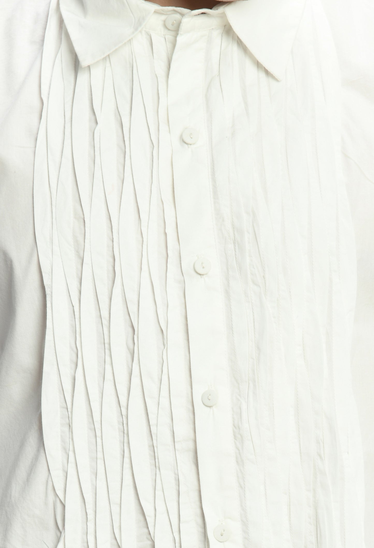 A white cotton shirt showcasing asymmetric pintex in the front