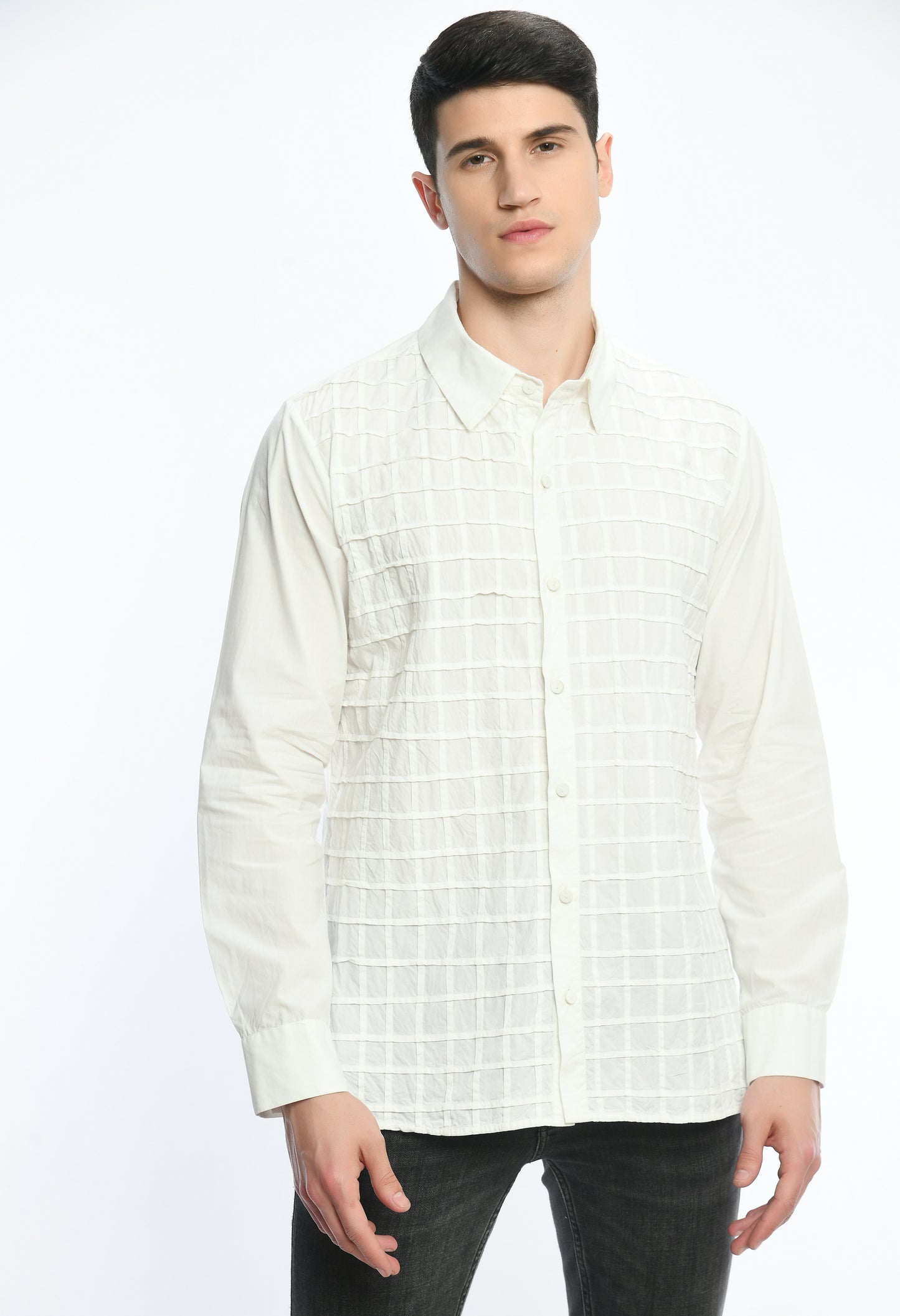 A white cotton shirt showcasing pintex lines creating a check tone on tone pattern.