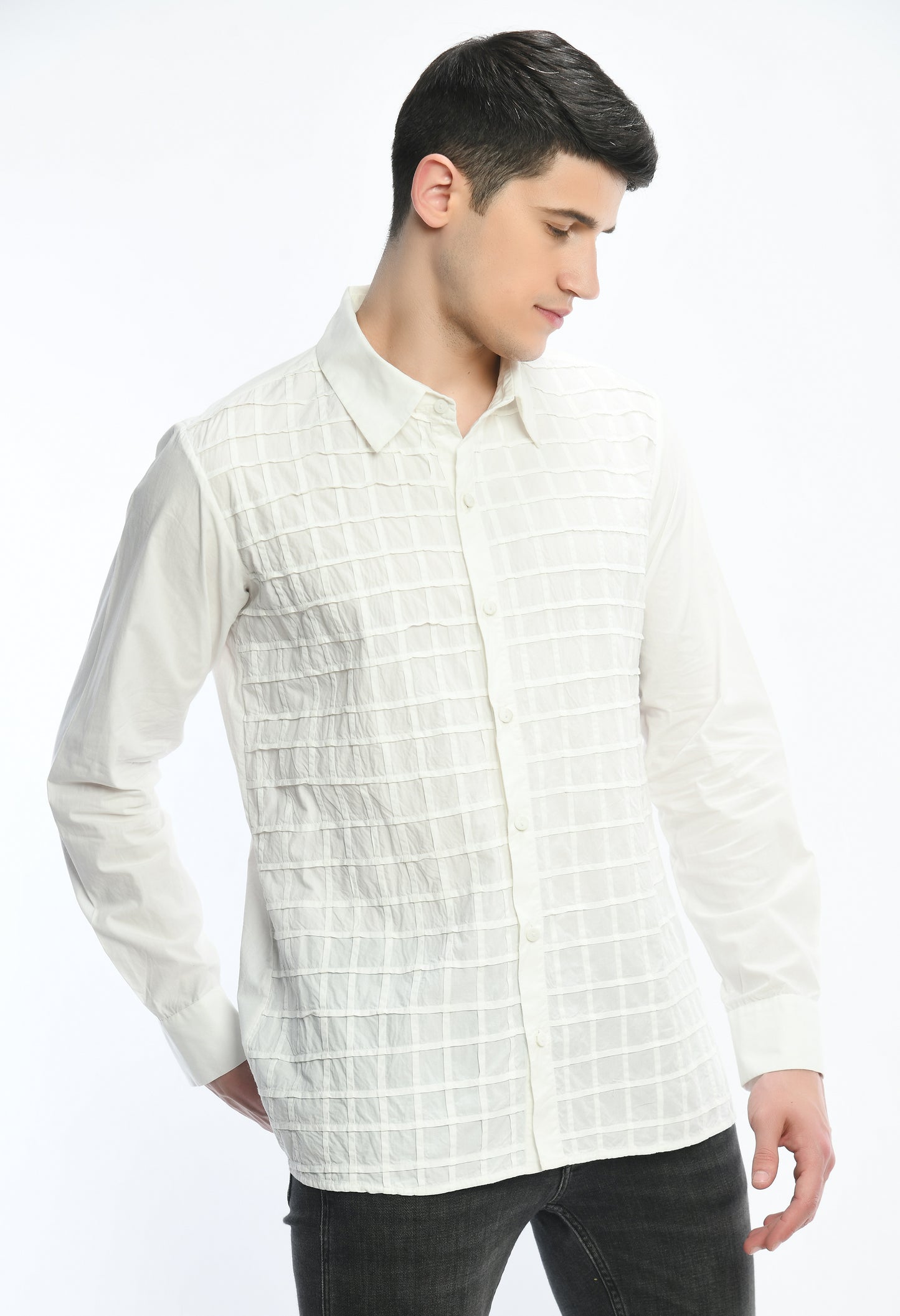 A white cotton shirt showcasing pintex lines creating a check tone on tone pattern.