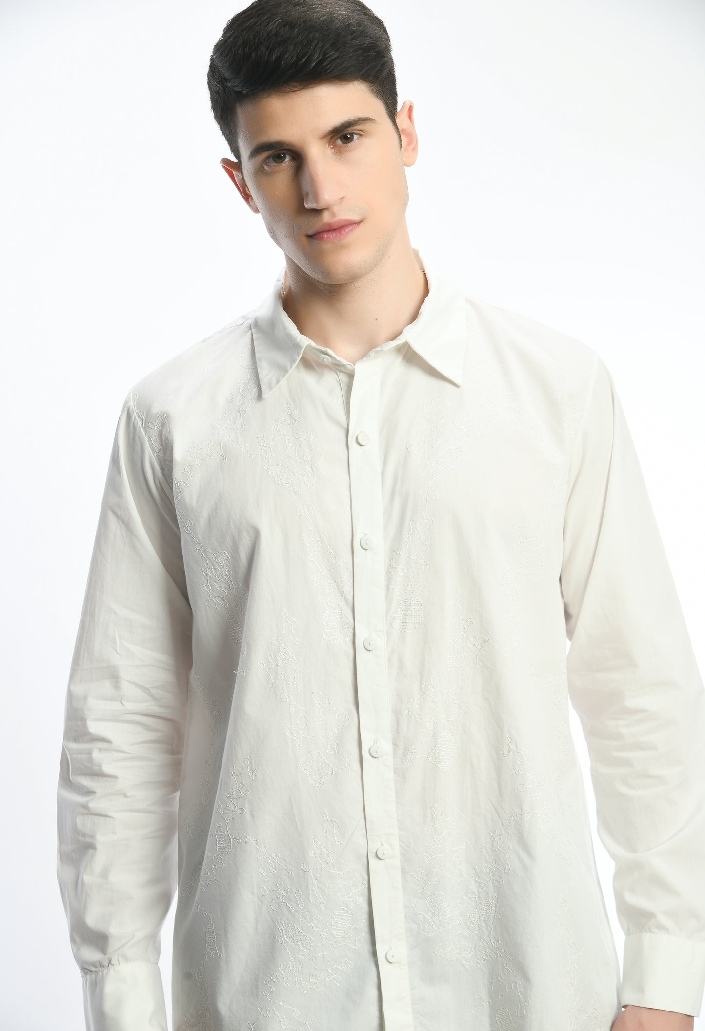 A white cotton shirt showcasing tone on tone abstract thread embroidery