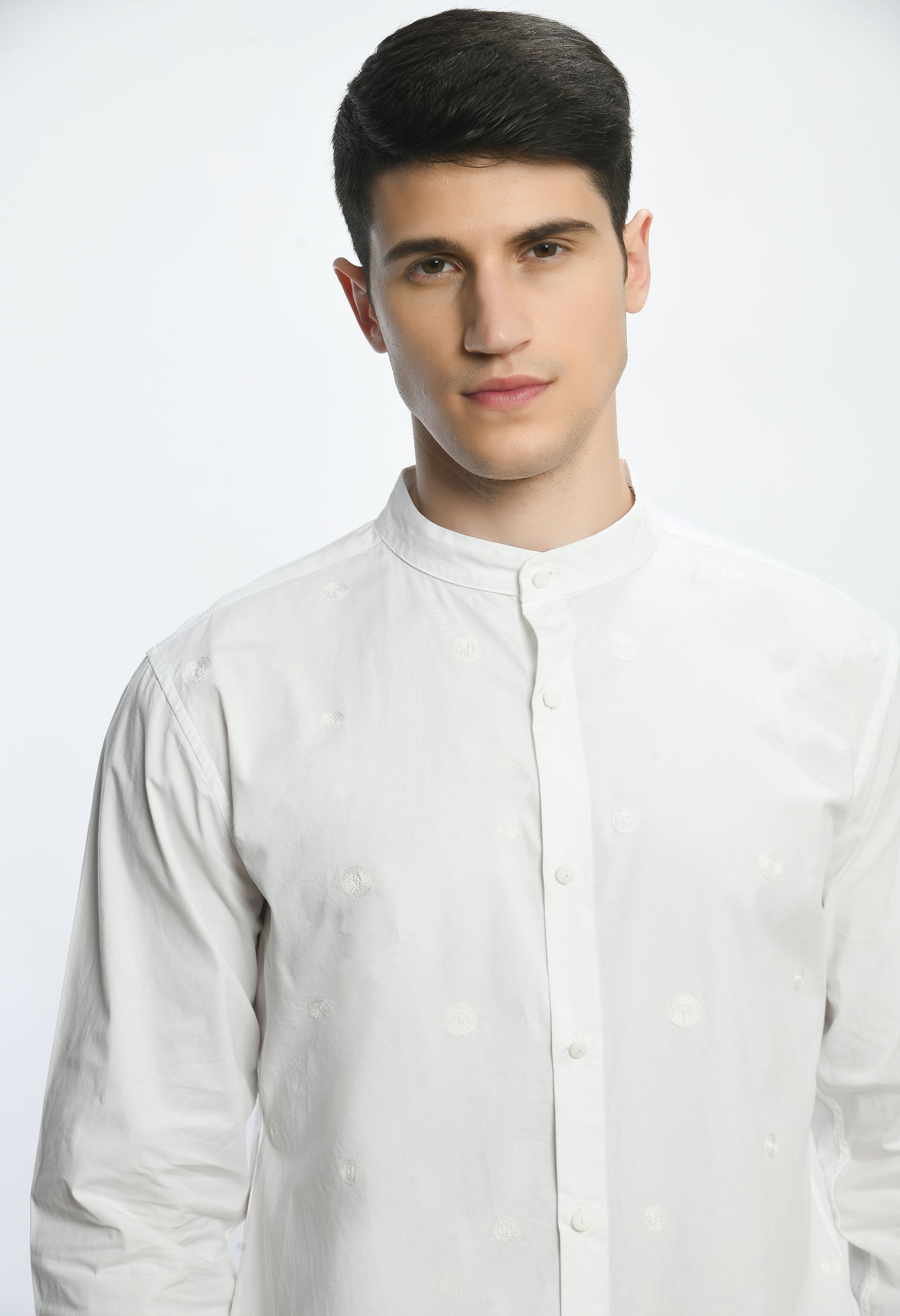A white cotton shirt with band neckline, showcasing tone on tone thread embroidery