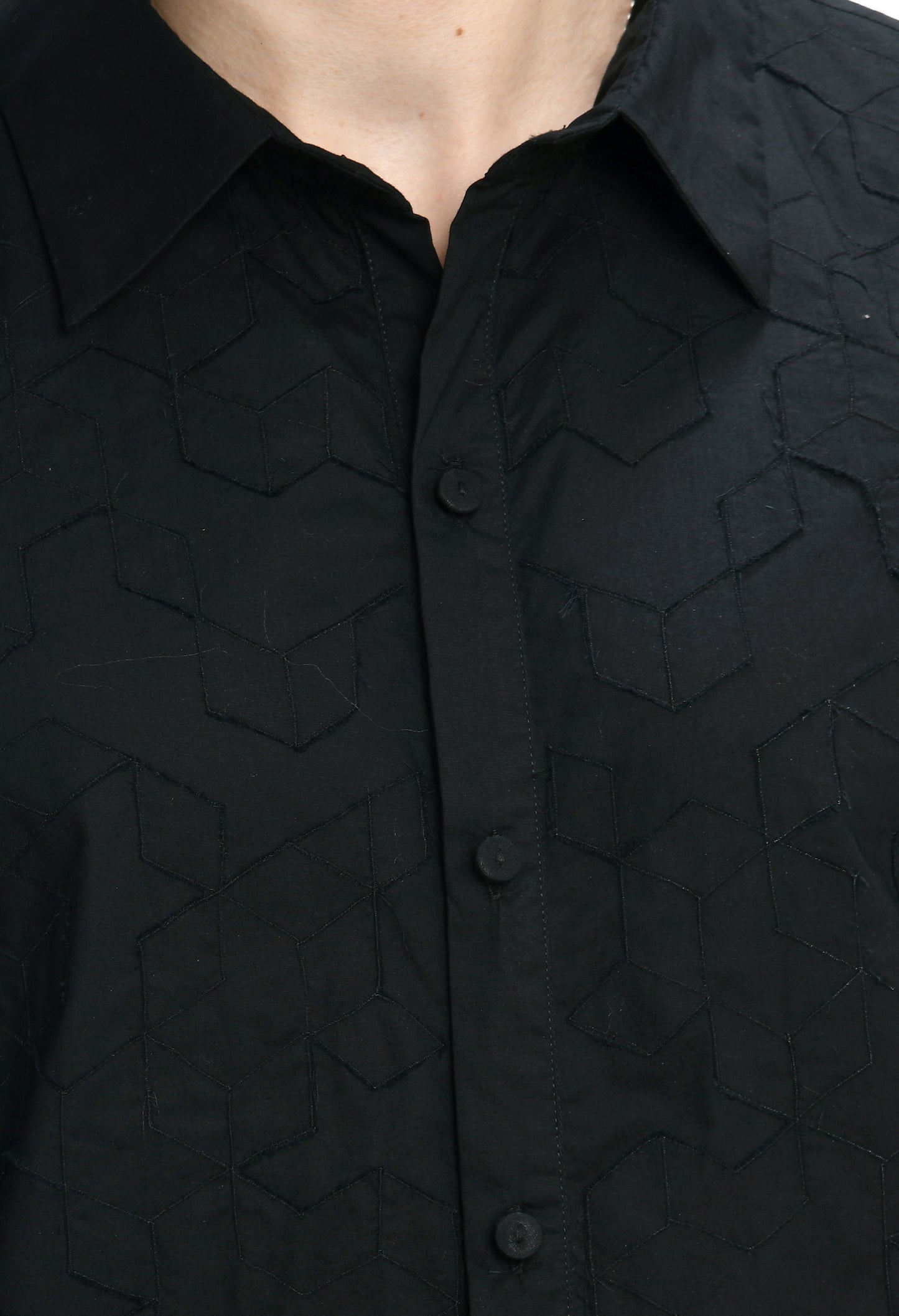 A black cotton shirt showcasing tone on tone appliqué work.