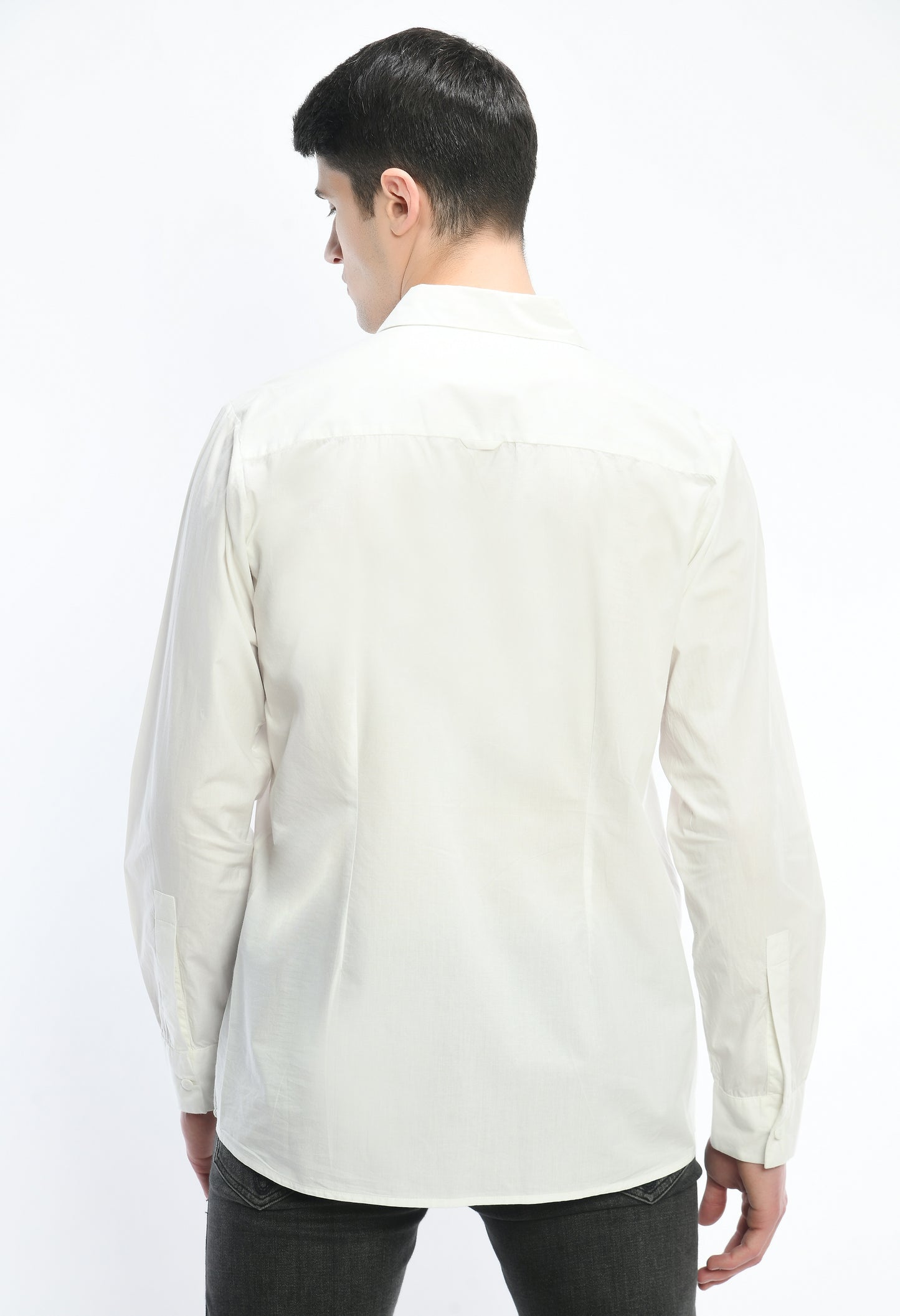 A white cotton shirt showcasing tone on tone appliqué work.