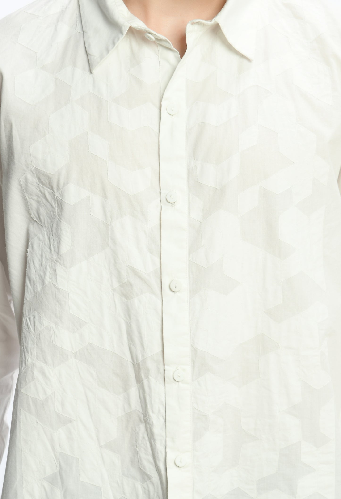 A white cotton shirt showcasing tone on tone appliqué work.