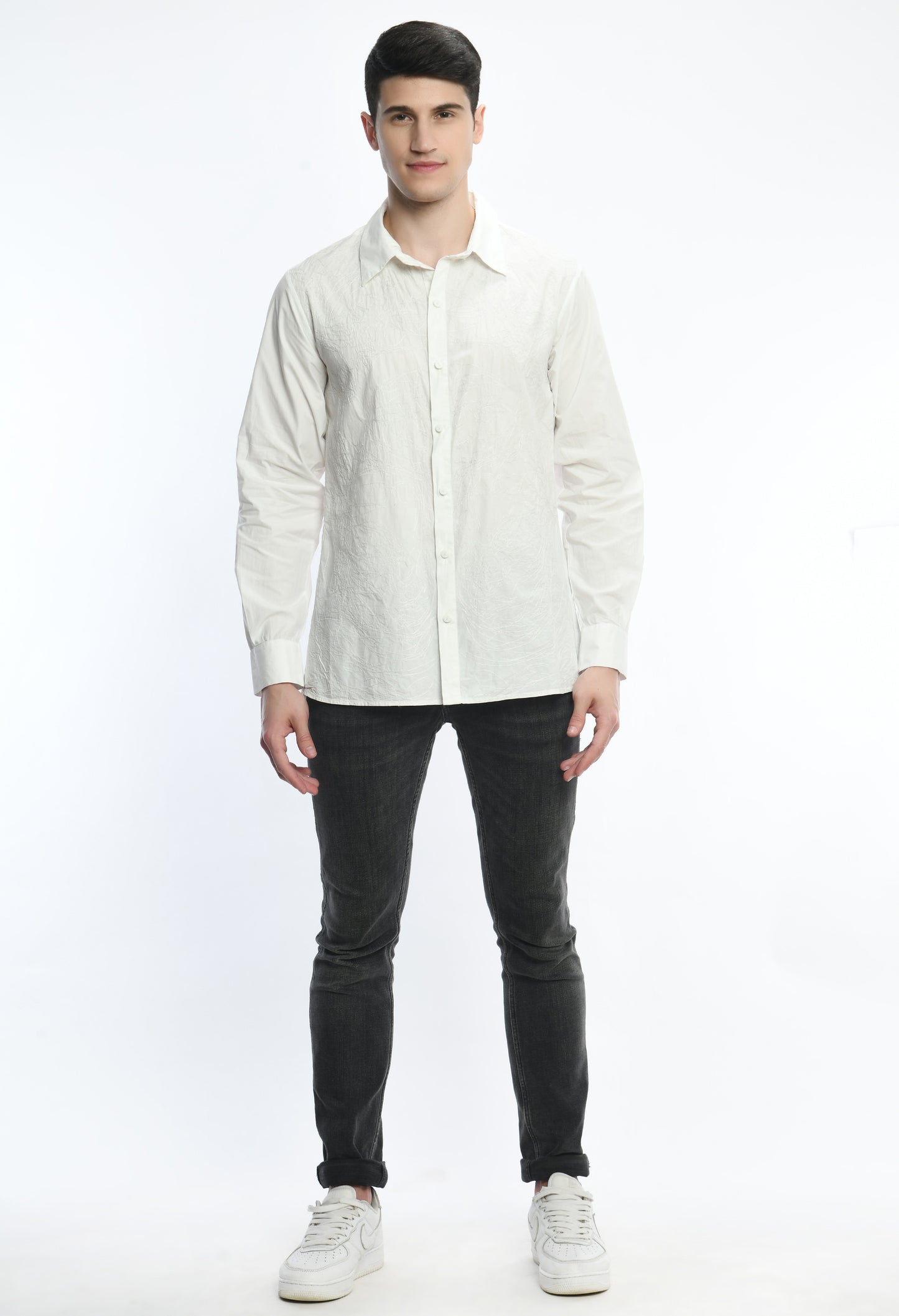 A white cotton shirt showcasing tone on tone abstract thread embroidery
